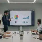 Entrepreneurs presenting a pitch deck to focused investors in a modern meeting room